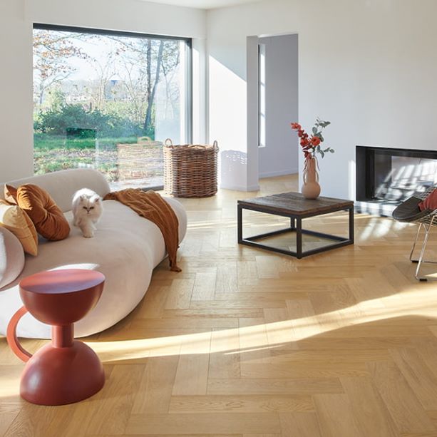 Minimaluxe living room with herringbone Quick-Step wooden floor